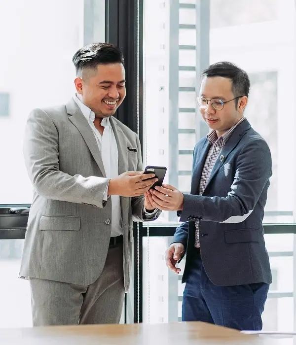 Two happy men seeing mobile